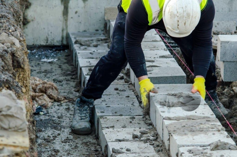 employee laying bricks